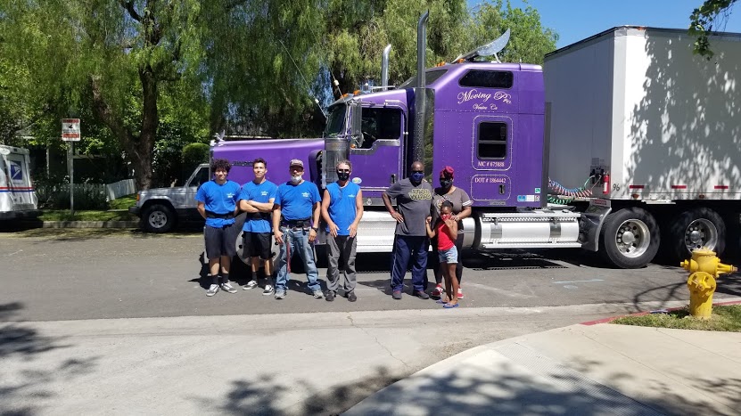 Moving Pro crew carefully unloading furniture